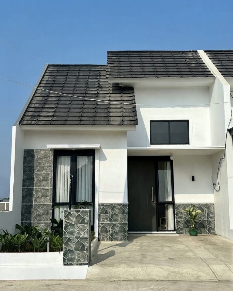 Tampak depan rumah modern Elmira Residence dengan carport dan taman botanikal asri